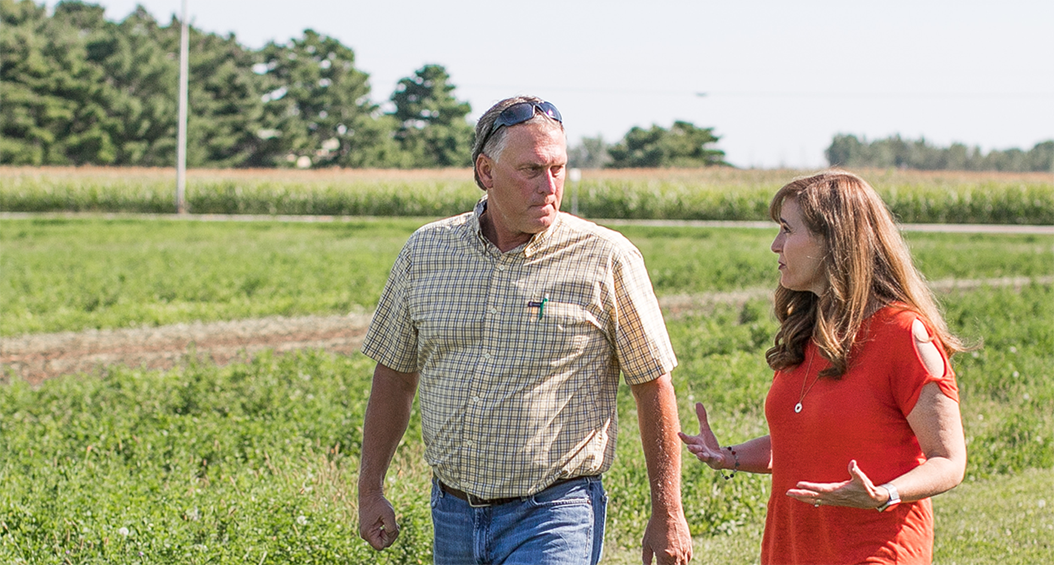 Theresa Gavarone speaking with a farmer